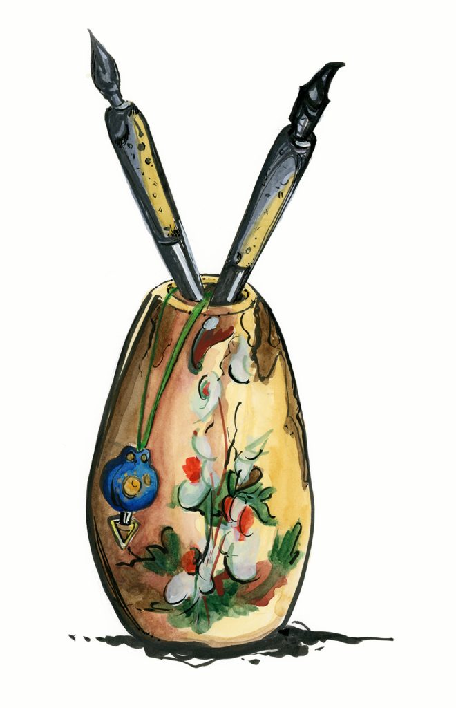 vase with ink pens and cell phone charm
